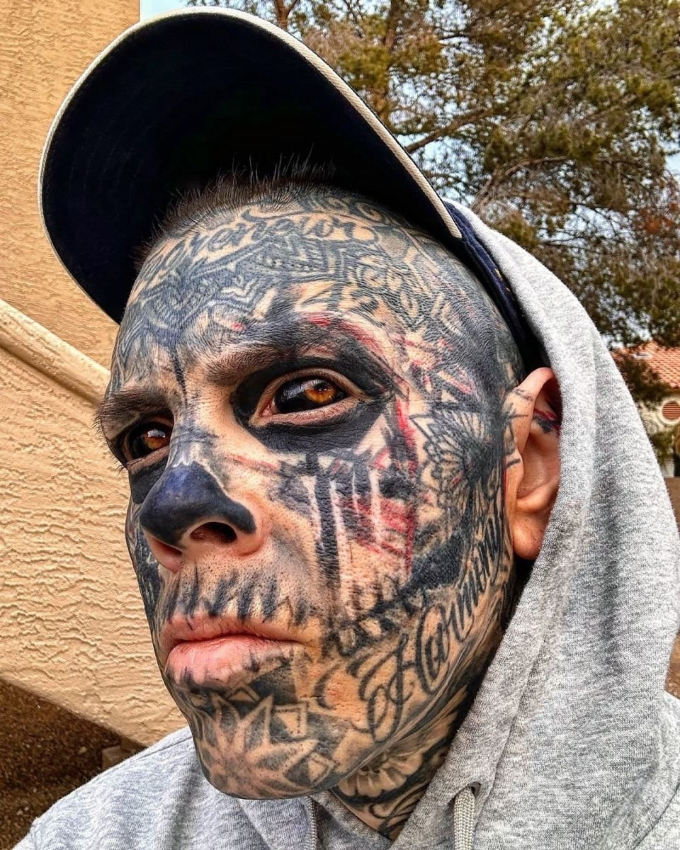 Closeup shot of Quest Gulliford's face covered in tattoos with even his eyeballs tattooed, Photo Credit: questg/Instagram